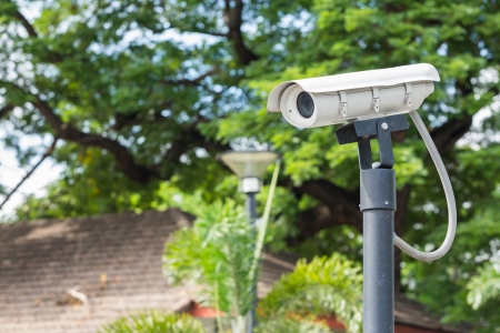 White CCTV camera watching for security 24 hours at car parkの写真素材