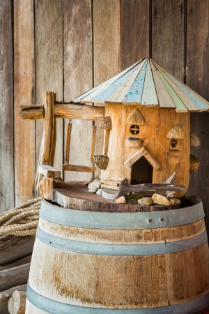 Mini wooden house model on old wine barrelの写真素材