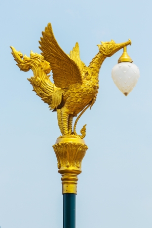 Golden color mythical female bird sculpture lamp on streetの写真素材