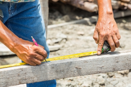 Worker use cartridge meter measuring in construction siteの写真素材