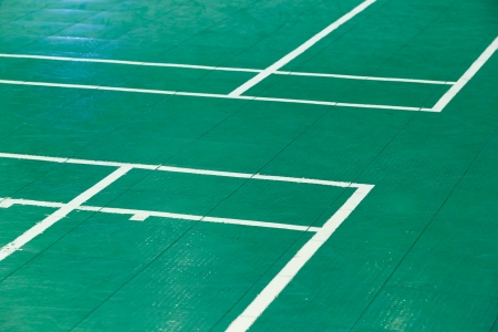 Close up corner of old and dirty green color badminton court with white lineの写真素材