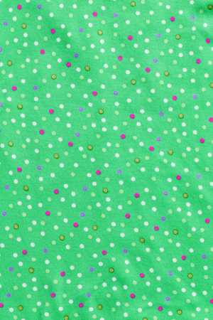 Close up green stretch fabric with multi color dot textureの写真素材