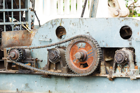 Close up dirty old gear and chain on piling machine