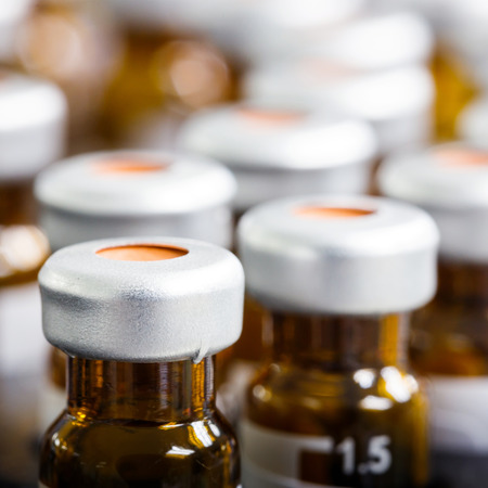 Close up amber color vials with inserts and crimp septum capsの写真素材