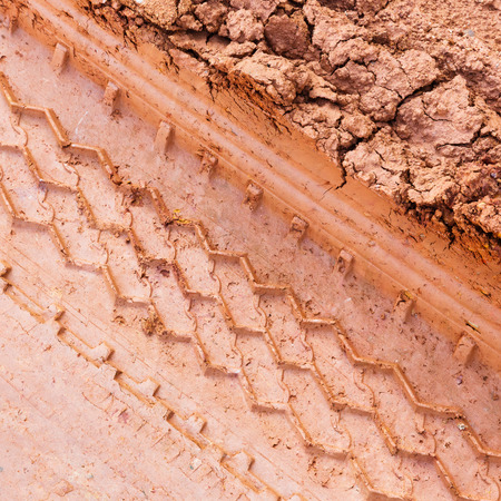 Close up tire track on red color lateritic soilの写真素材