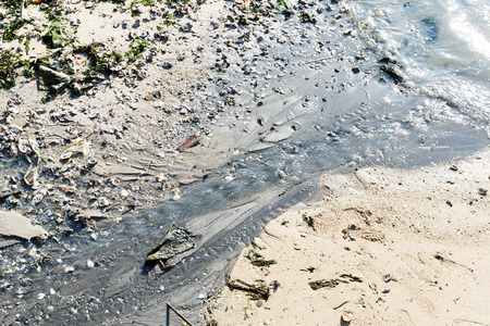 Close up dirty waste water flows into the seaの写真素材