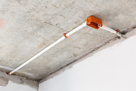 Close up electrical distribution system installation on ceiling in new buildingの写真素材