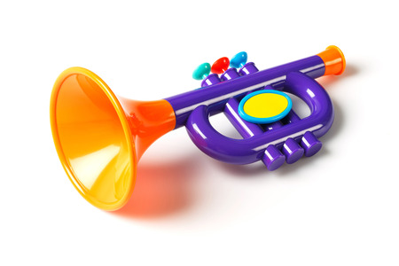 Close up plastic toy trumpet for children isolated on whiteの写真素材