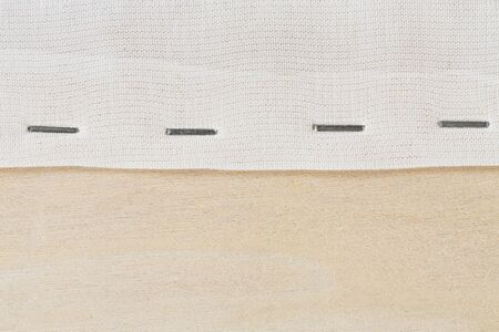 Close up staple cloth end on wooden frameの写真素材