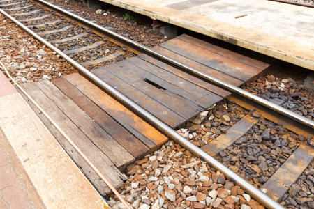 Close up old and drty wooden walkway across railwayの写真素材
