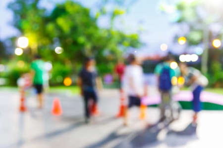 Abstract blur people walking in community mall at night, urban lifestyle conceptの写真素材