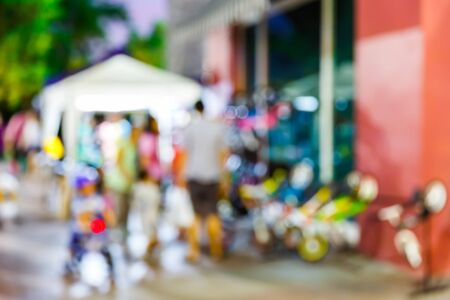 Abstract blur people walking in community mall at night, urban lifestyle conceptの写真素材