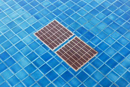 Close up drain grid at bottom of poolの写真素材