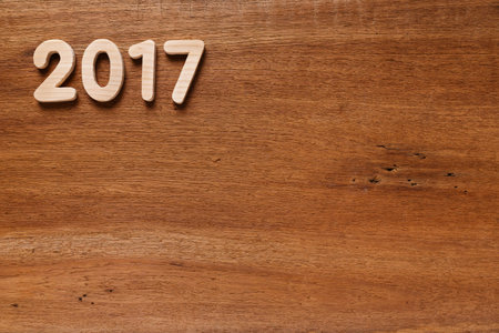 Year 2017 alphabet letter numeric number on old wooded background