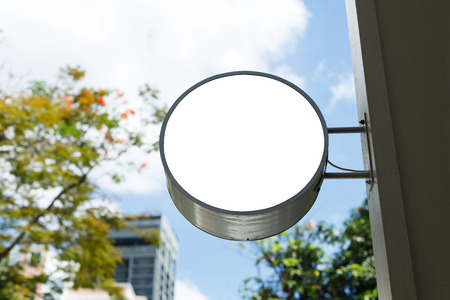 Empty shop circular shape lightbox mounted on wall for logo or advertisingの写真素材