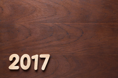 Year 2017 alphabet letter numeric number on old wooded background