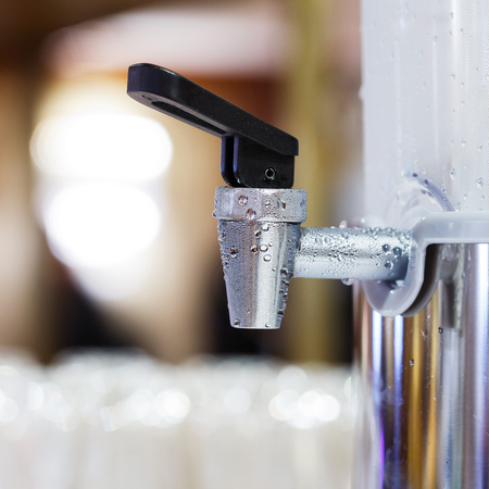 Close up water droplet on stainless steel dispenser cooler valveの写真素材