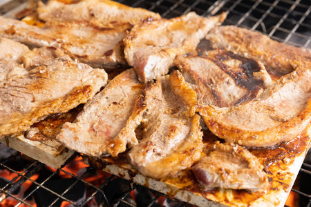 Grilled beef steak on marble stone over charcoal, natural heat for cookingの写真素材