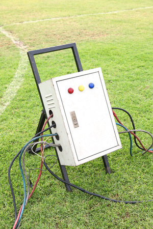 Old and dirty outdoor electrical power distribution box with circuit breaker and signal lights,...