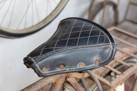 Closeup Old and dirty bicycle leather seat, old-fashioned styleの写真素材