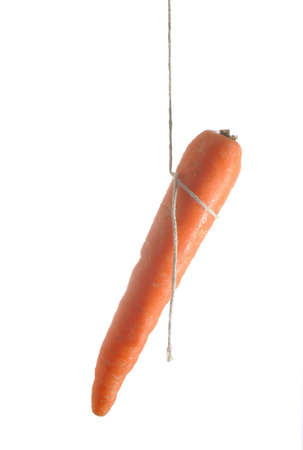 Carrot dangling on a piece of string implying chasing the dream.の写真素材