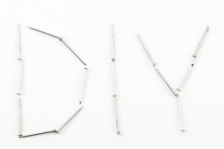 Shiny silver nails making the word DIYの写真素材