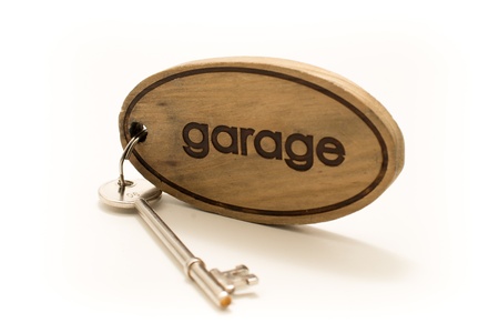Large Wooden Garage Key Fob with a large metal key attachedの写真素材