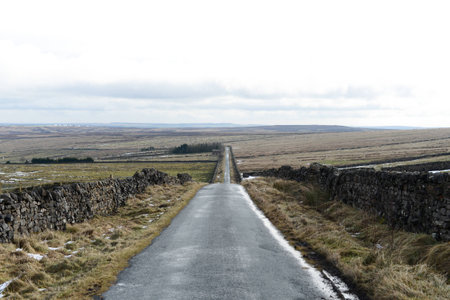 Long countryside road in the hills and mountains of Englandの写真素材