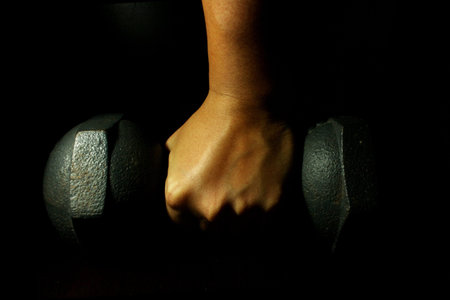 Working out with dumbbellの写真素材