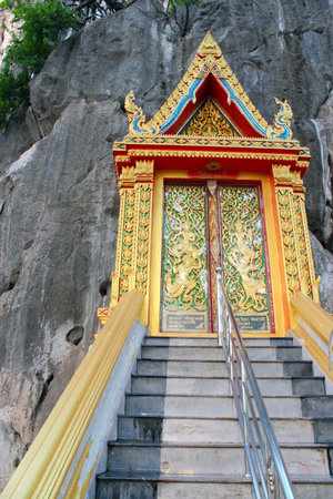 Traditional Thai style on door in temple phetchaburi ,Thailand