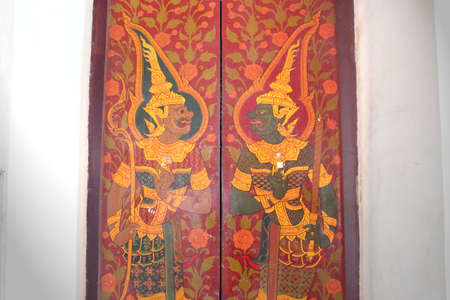 Native Thai style carving, painting on church door in the templeのeditorial素材