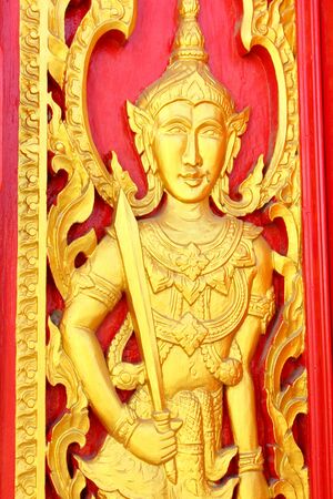 Native Thai style carving, painting on church door in the templeの写真素材