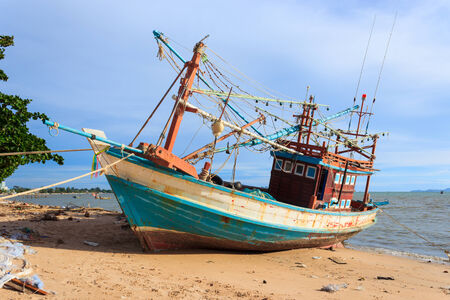 Wooden fishing boat on the beach の写真素材