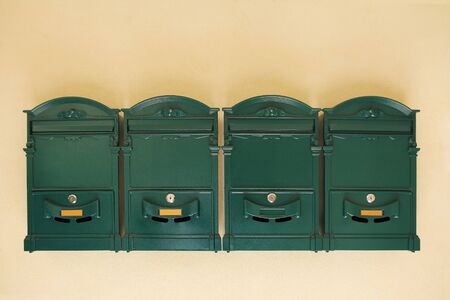 Antique Green Letter Boxes on the wallの写真素材