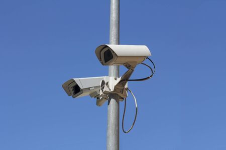 Security camera on blue sky backgroundの写真素材