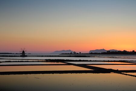 Old windmills on the salt pans in Sicilyの写真素材
