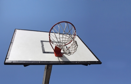 Basketball backboard on the school basketball court under blue skyの写真素材