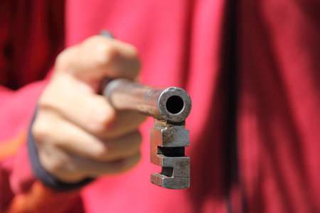The antique large iron key in hand 