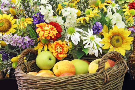 Basket full of apples and lots of flowersの写真素材
