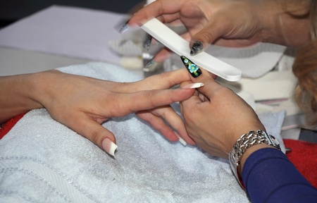 Beautician in a salon manicure fingernails a female personの写真素材