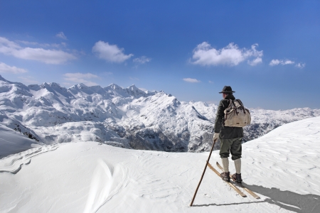 Old skier with traditional old wooden skis and backpackの写真素材