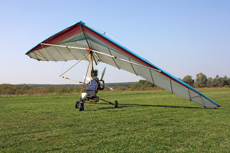 Trike with colorful wing, on a green meadow