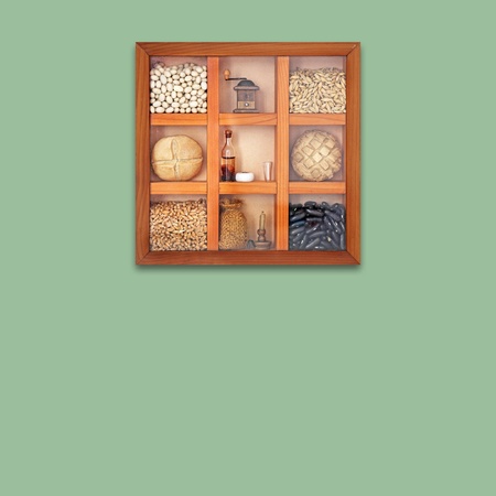 Assortment of beans, cereal and breads in wooden box on a green wallの写真素材