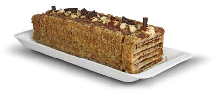 Delicious and sweet cake with nuts and chocolate on white plateの写真素材