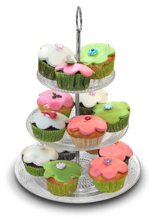 Pile of colorful muffins, stacked in a pyramid, isolated on whiteの写真素材