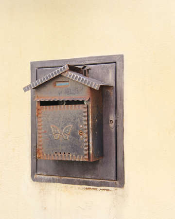 Old and rusty mailbox on the facade of the houseの写真素材