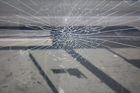 Glass broken cracks splinters in front of the bus station