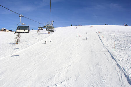 Ski lift and skiers on the Mountain ski resort Gerlitzen, Austriaの写真素材