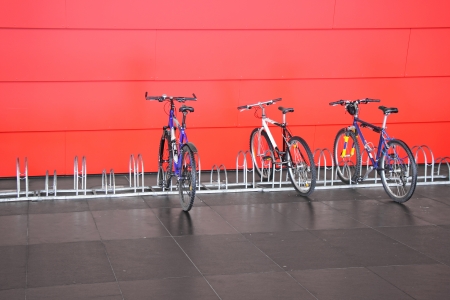 Metal spiral holder for bikes set up in front of retail storeの写真素材