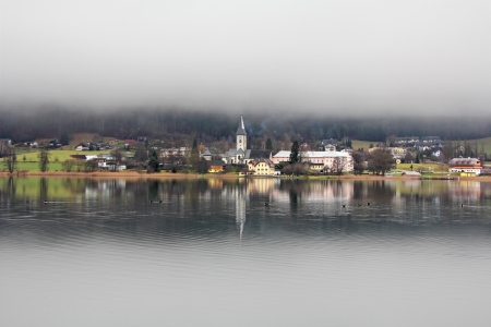 Lake landscape at Ossiacher See, misty winter dayの写真素材